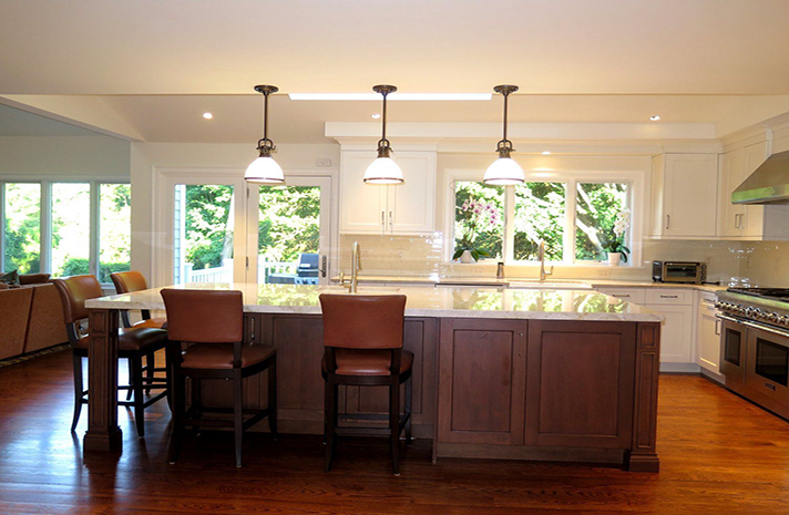 A kitchen with a large island and stools