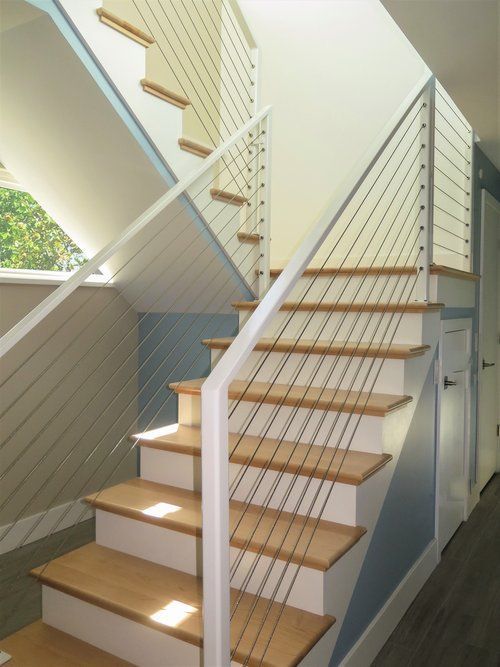 A staircase with a white railing and wooden steps