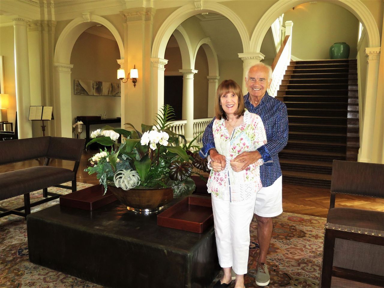 A man and woman are posing for a picture in a living room