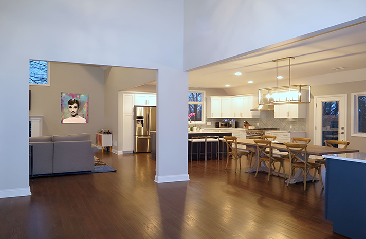 A living room , dining room , and kitchen in a house.