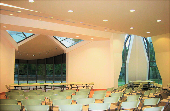 A large room with tables and chairs in it