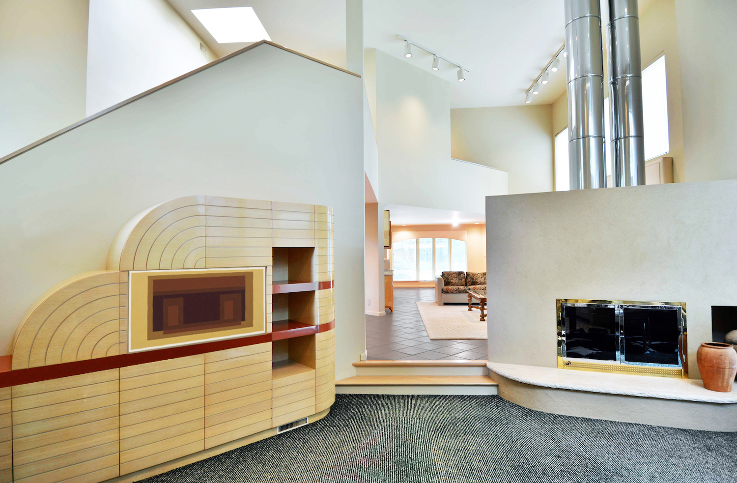 A living room with a fireplace and stairs