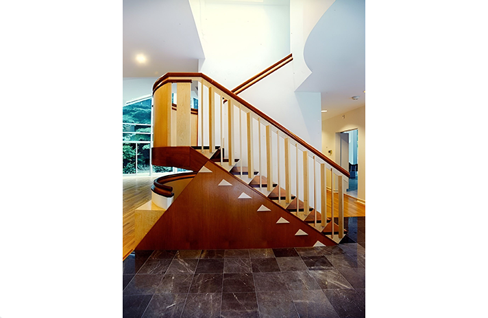 A wooden staircase with triangles on the steps