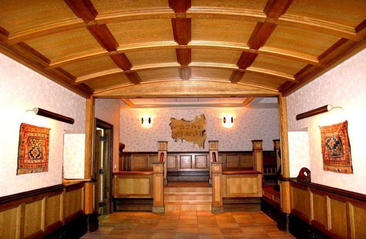 A hallway with a wooden ceiling and stairs