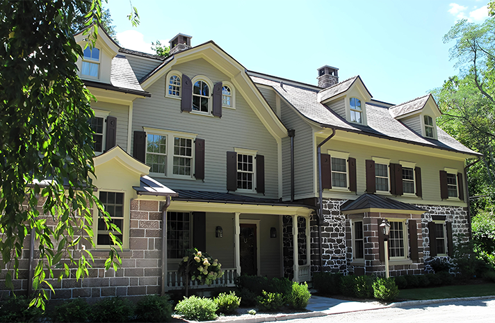 A large house with a lot of windows and shutters