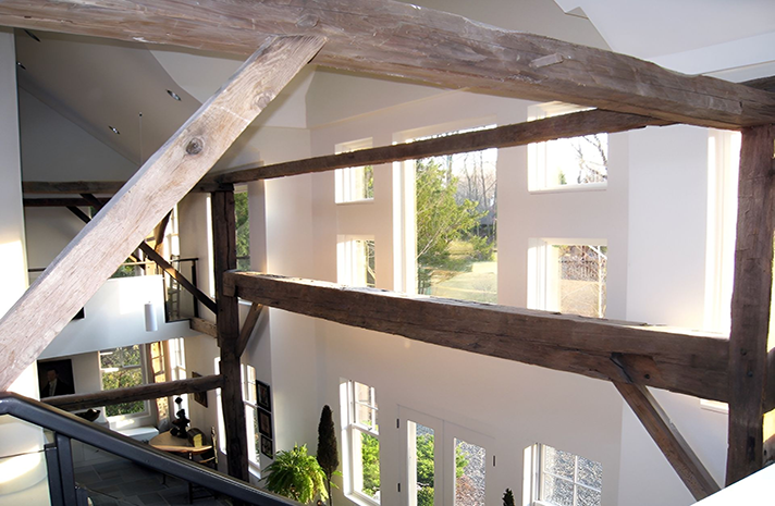 A house with a lot of windows and wooden beams