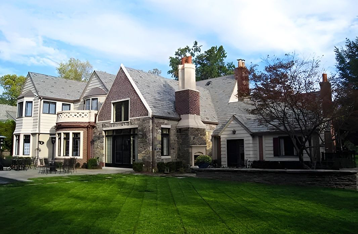 A large house with a large lawn in front of it