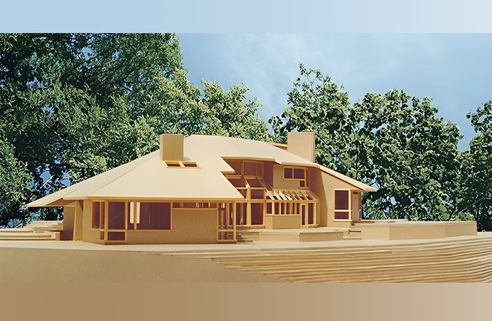 A model of a house with trees in the background