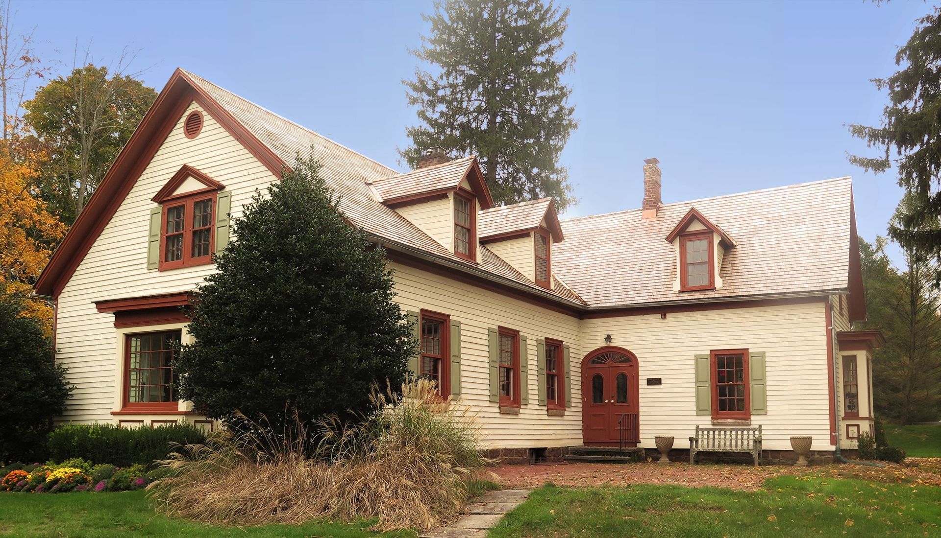 A large white house with a red door and shutters