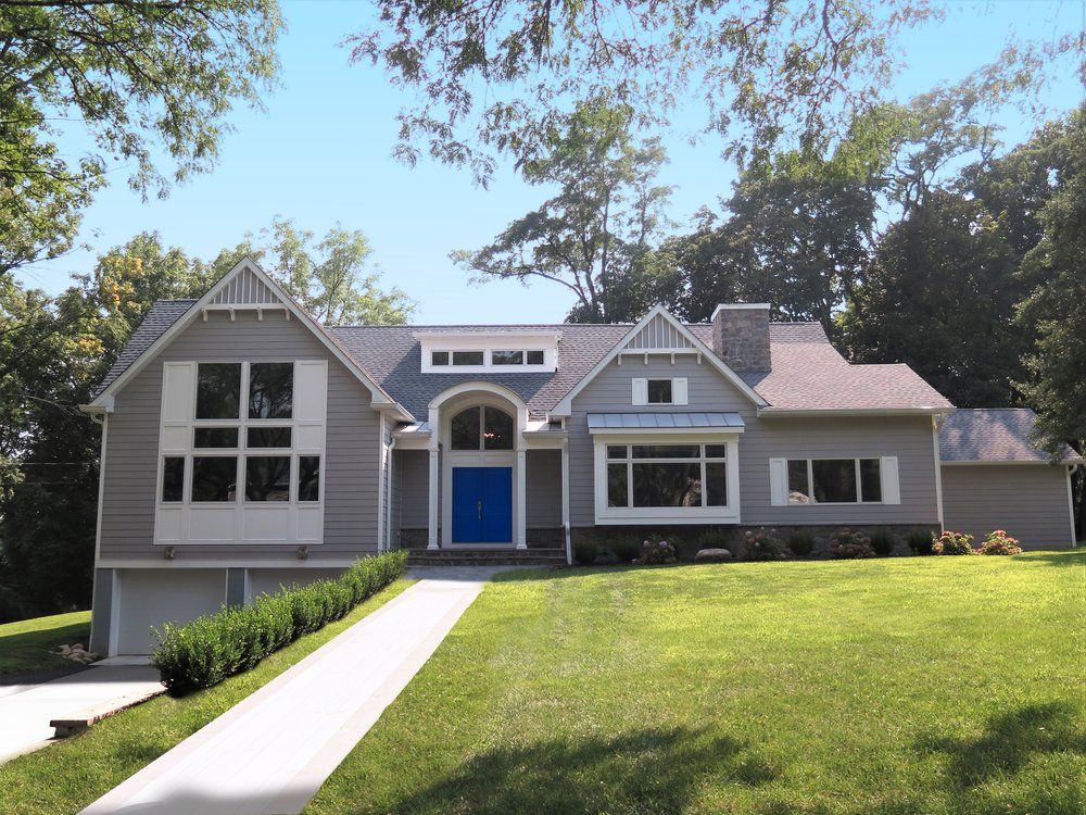 A large house with a blue door and white trim