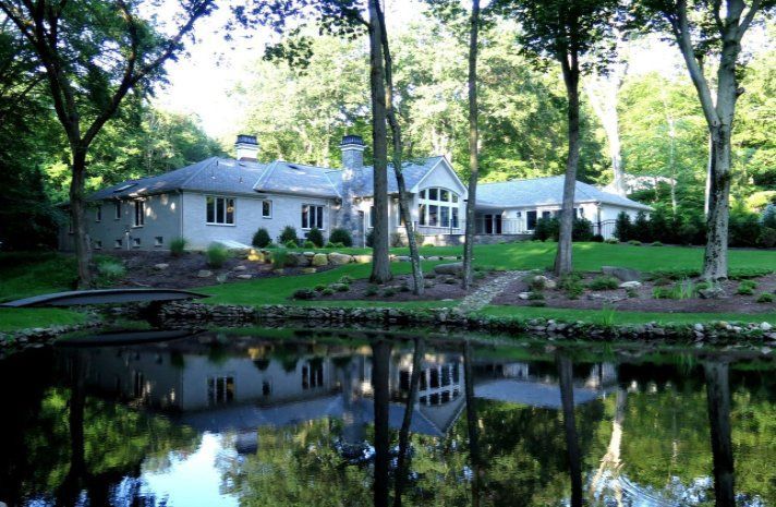 A house with a pond in front of it