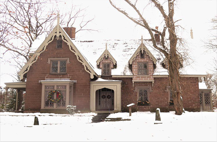 A large brick house with snow on the roof