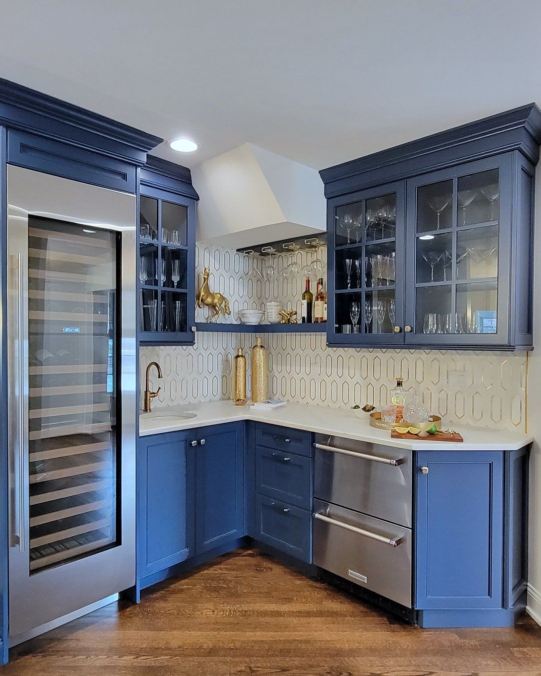 A kitchen with blue cabinets and stainless steel appliances.