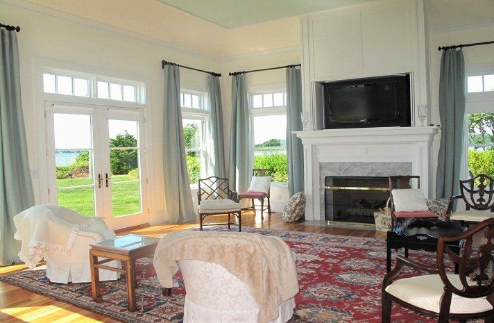 A living room with a fireplace and a flat screen tv