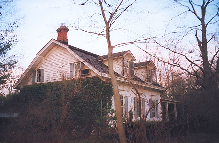 A white house with a chimney on top of it