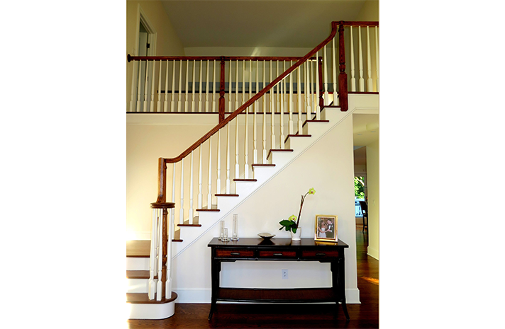 A staircase in a house with a table underneath it