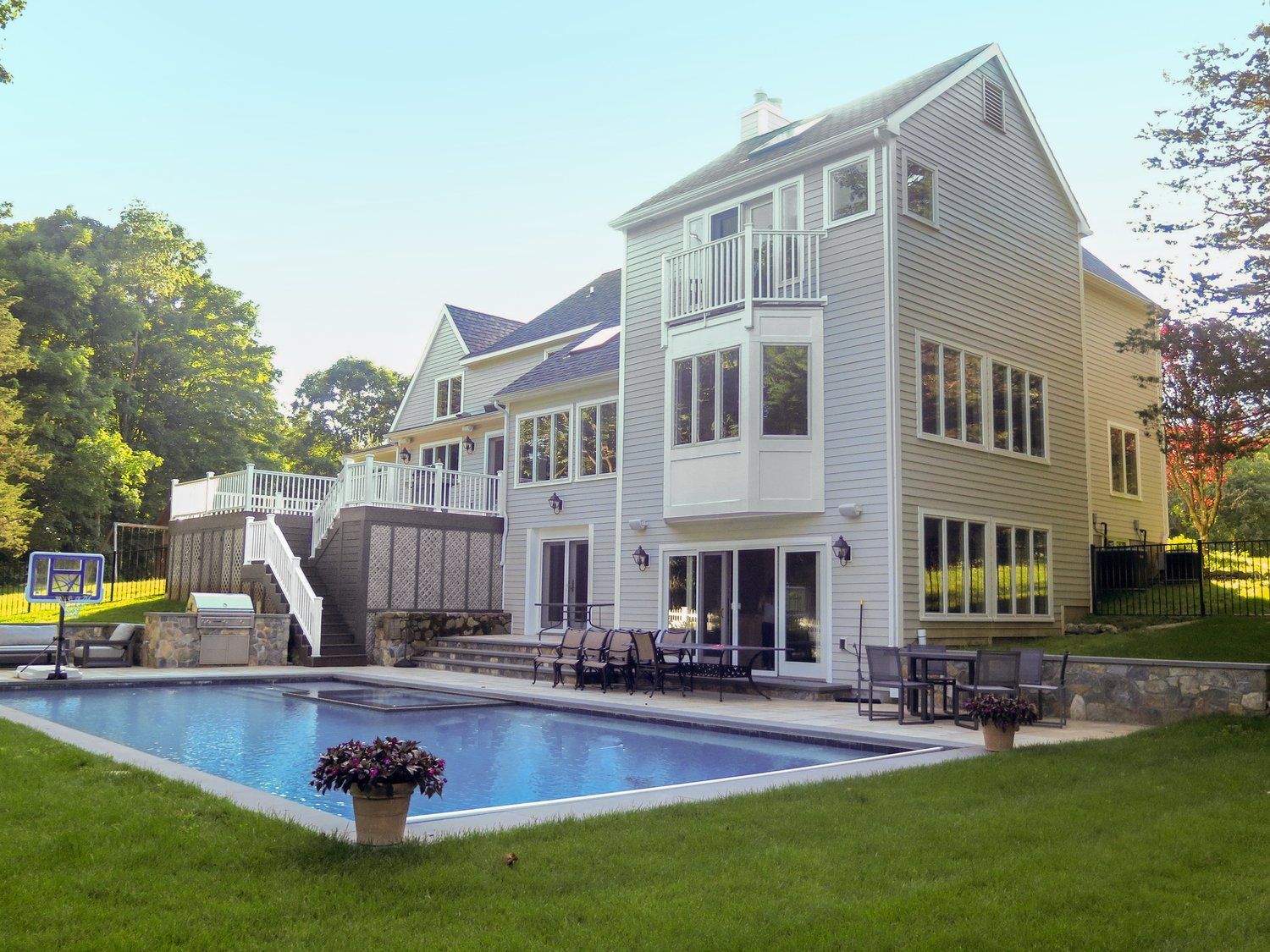 A large house with a large swimming pool in front of it
