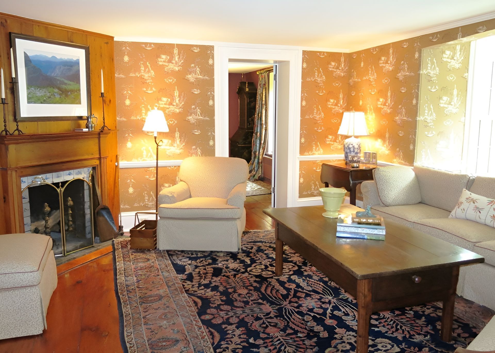 A living room with a couch a chair a coffee table and a fireplace