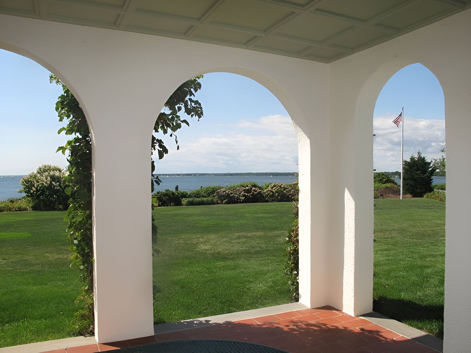 A view of a grassy field with a flag in the distance