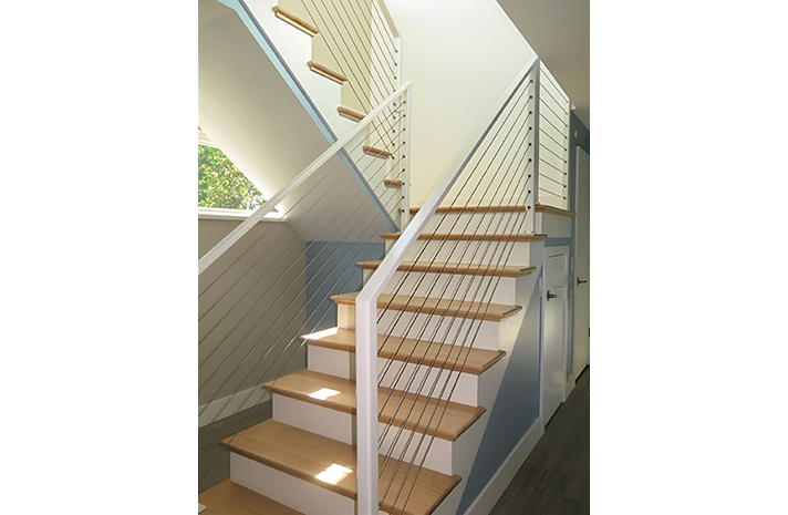 A staircase with wooden steps and a white railing