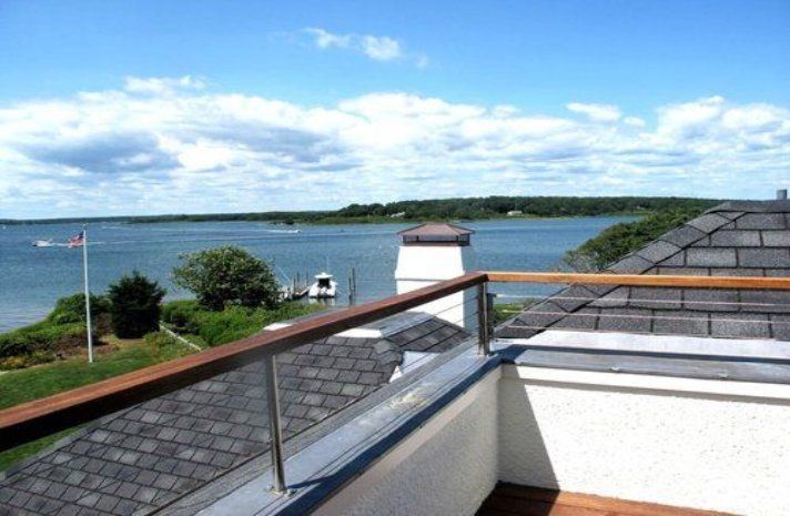 A balcony with a view of a body of water