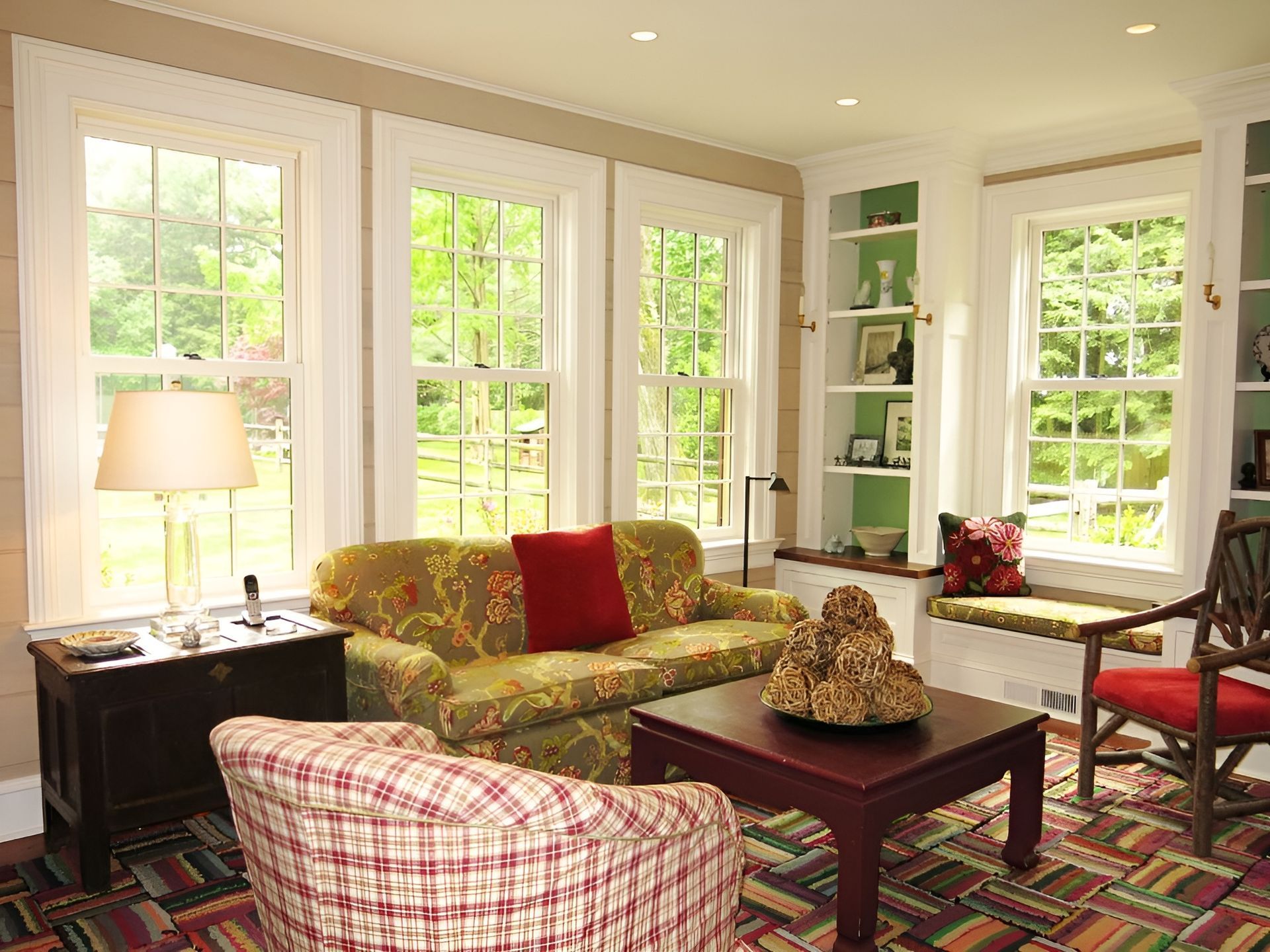 A living room with a couch , chairs , and a coffee table.
