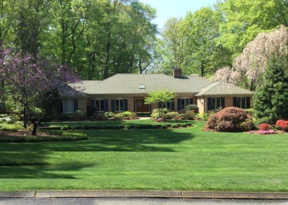 A large house with a lush green lawn in front of it