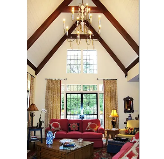 A living room with a chandelier hanging from the ceiling