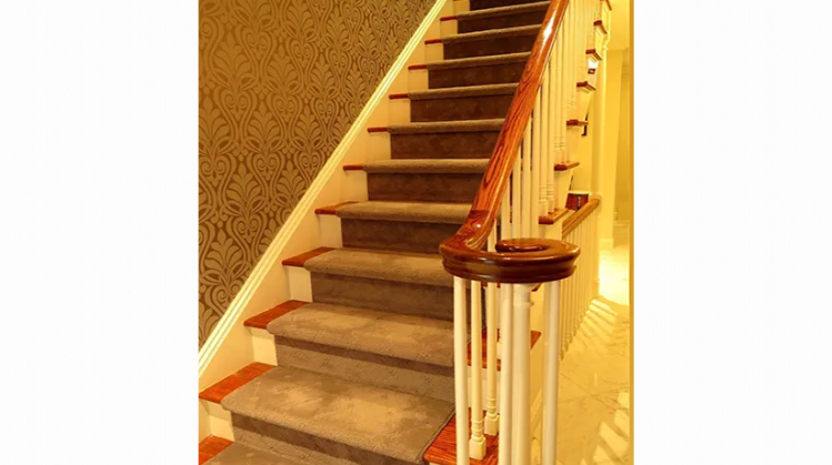 A staircase with carpeted steps and a wooden railing.