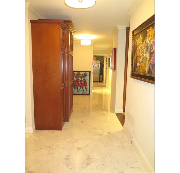 A hallway in a house with a painting on the wall