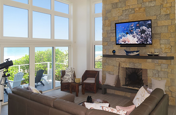 A living room with a couch a fireplace and a flat screen tv