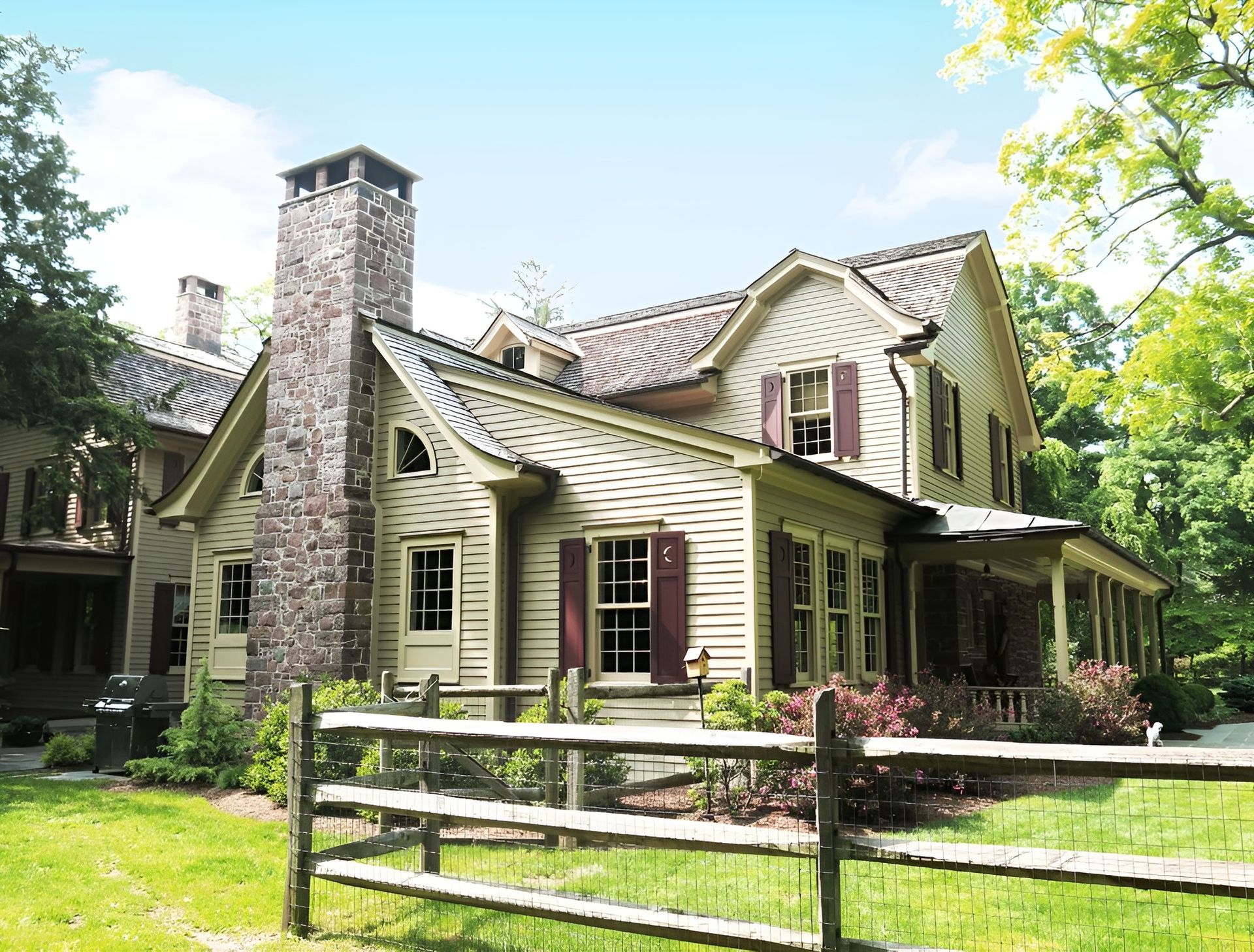 A large house with a wooden fence in front of it