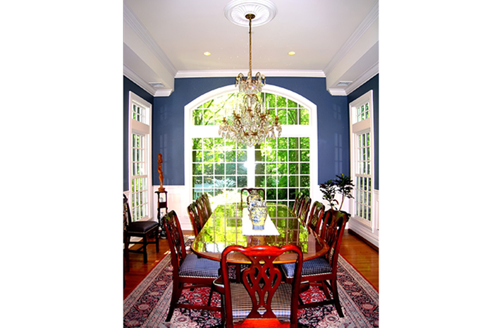 A dining room with a table and chairs and a chandelier