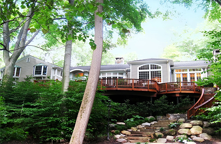 A house with a large deck and stairs leading up to it