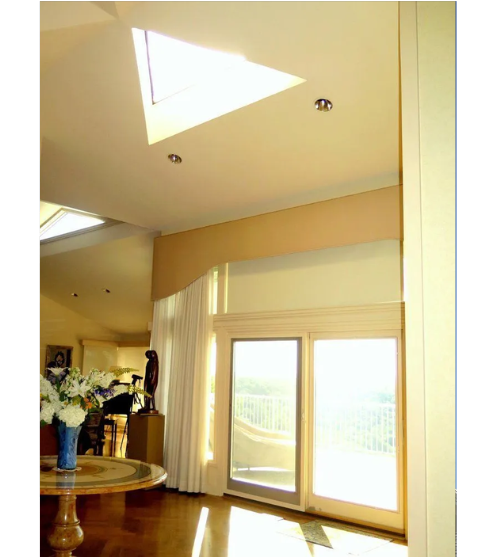 A living room with a skylight and a sliding glass door