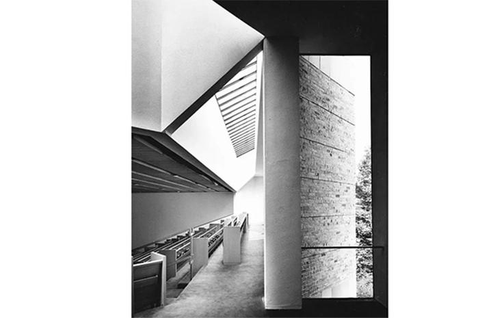 A black and white photo of a building with a window.