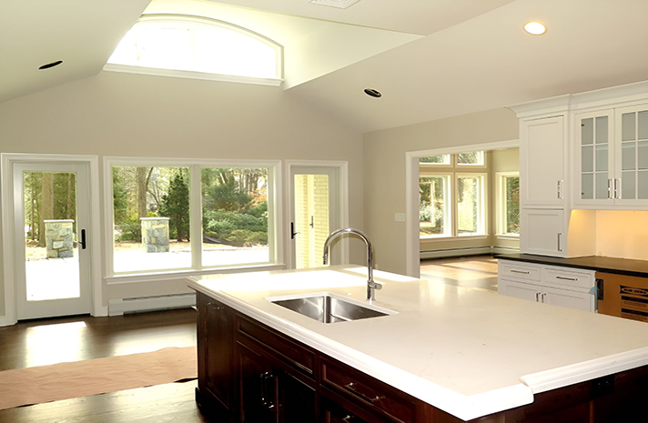 A kitchen with a large island and a sink
