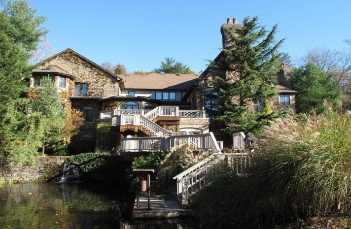 A large house with a bridge over a body of water