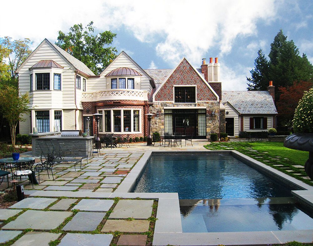 A large house with a large swimming pool in front of it