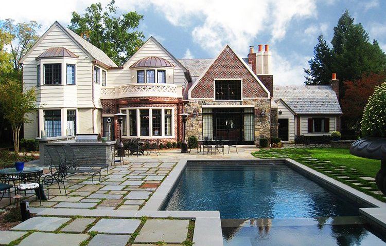 A large house with a large swimming pool in front of it