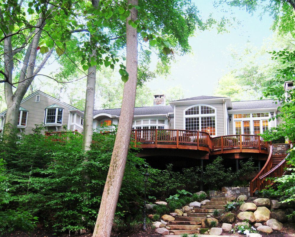 A house with a large deck and stairs leading up to it