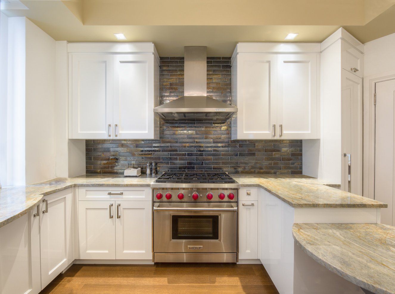 A kitchen with white cabinets and stainless steel appliances.