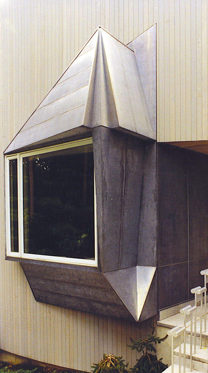 A house with a large window on the side of it