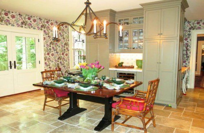 A dining room with a table and chairs and a chandelier.
