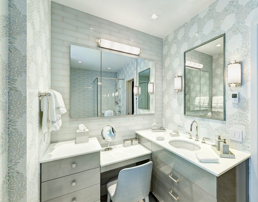 A bathroom with two sinks , a mirror and a vanity.