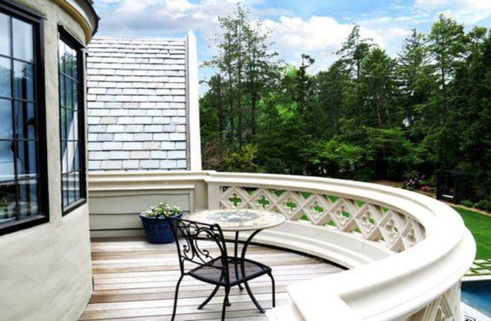 A balcony with a table and chairs on it