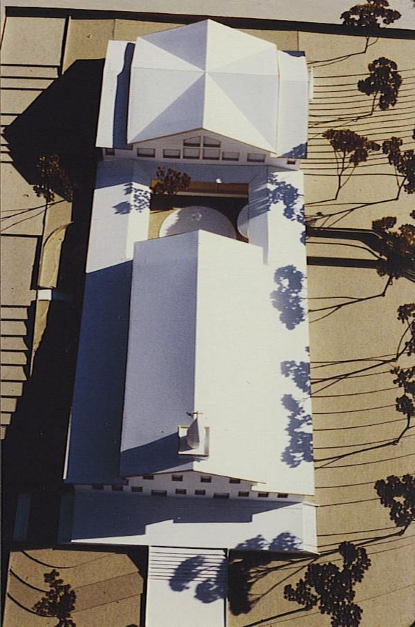 An aerial view of a house with a white roof