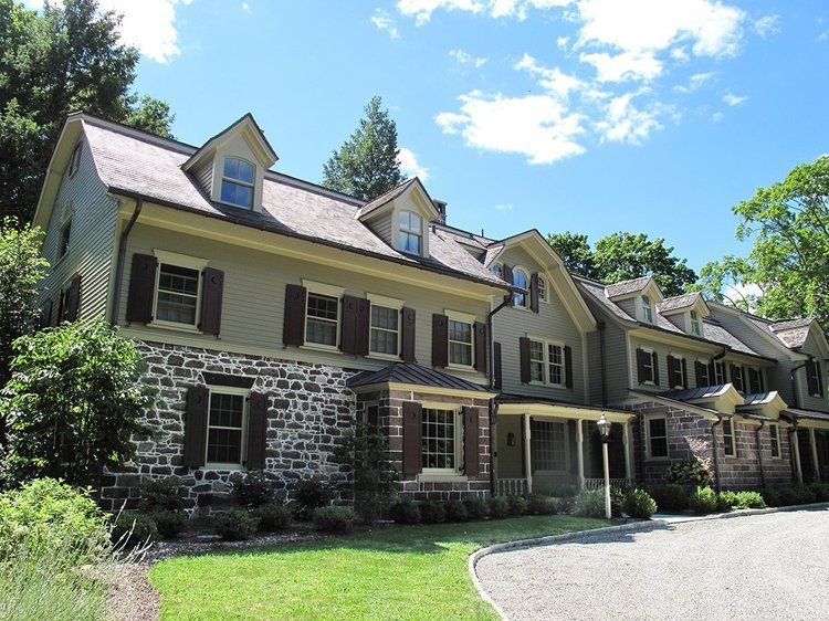 A large house with a lot of windows and shutters