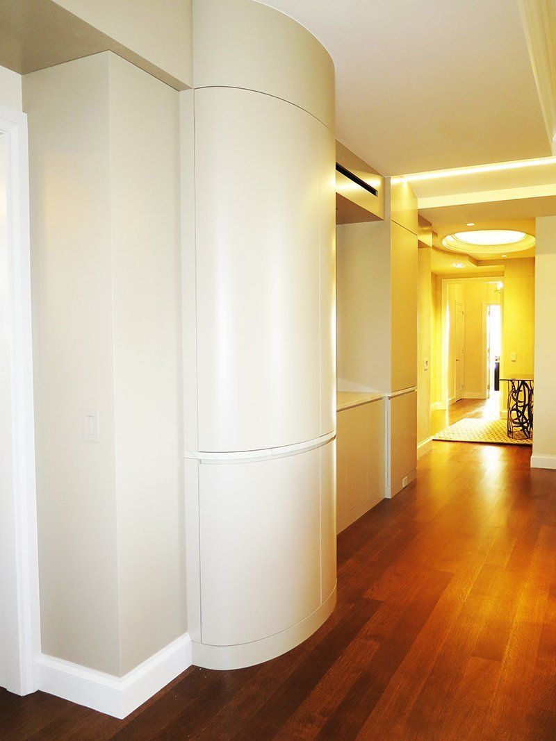 A hallway with hardwood floors and white walls