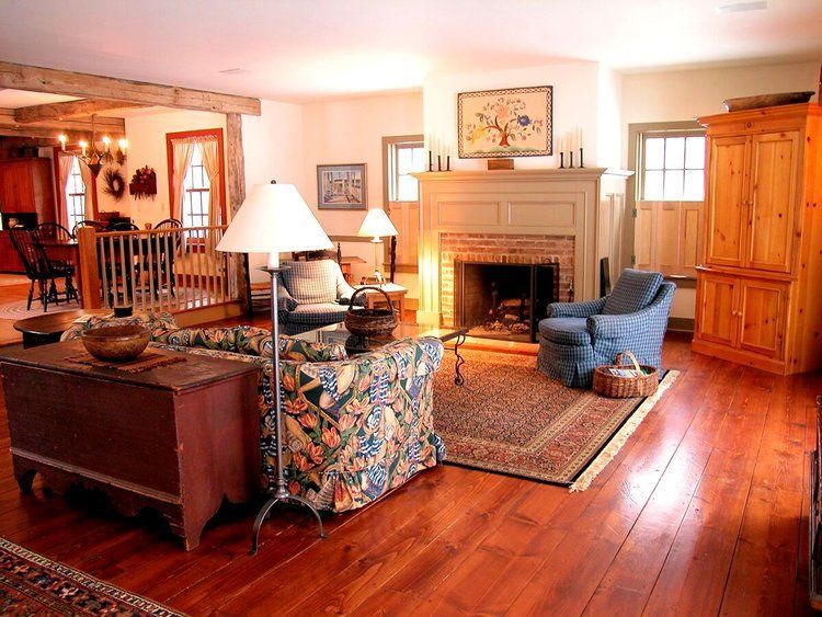 A living room with hardwood floors and a fireplace